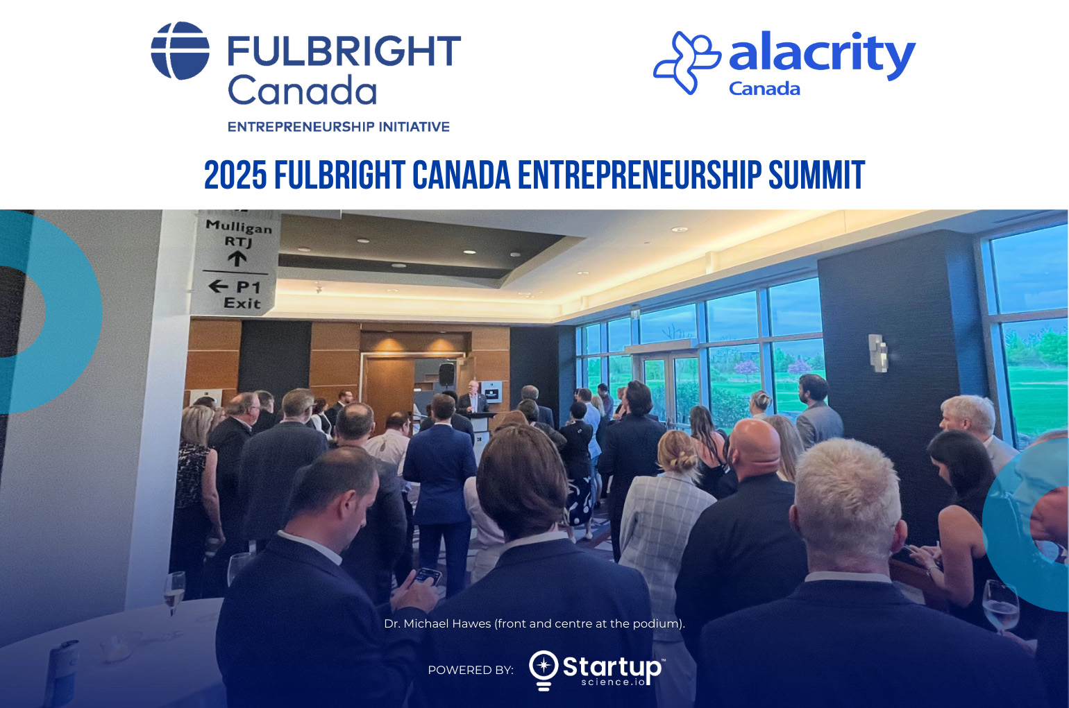 A large group of attendees stand and listen to a speaker at the podium during the 2025 Fulbright Canada Entrepreneurship Summit. Dr. Michael Hawes is front and center at the podium. The event is held in a modern conference room with large windows overlooking greenery. Fulbright Canada and Alacrity Canada logos are displayed at the top, and the event is powered by Startup Science.io.